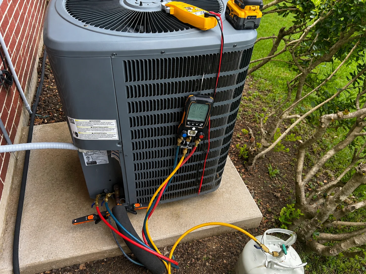 HVAC technician performing AC refrigerant diagnostic service in Caddo Mills TX