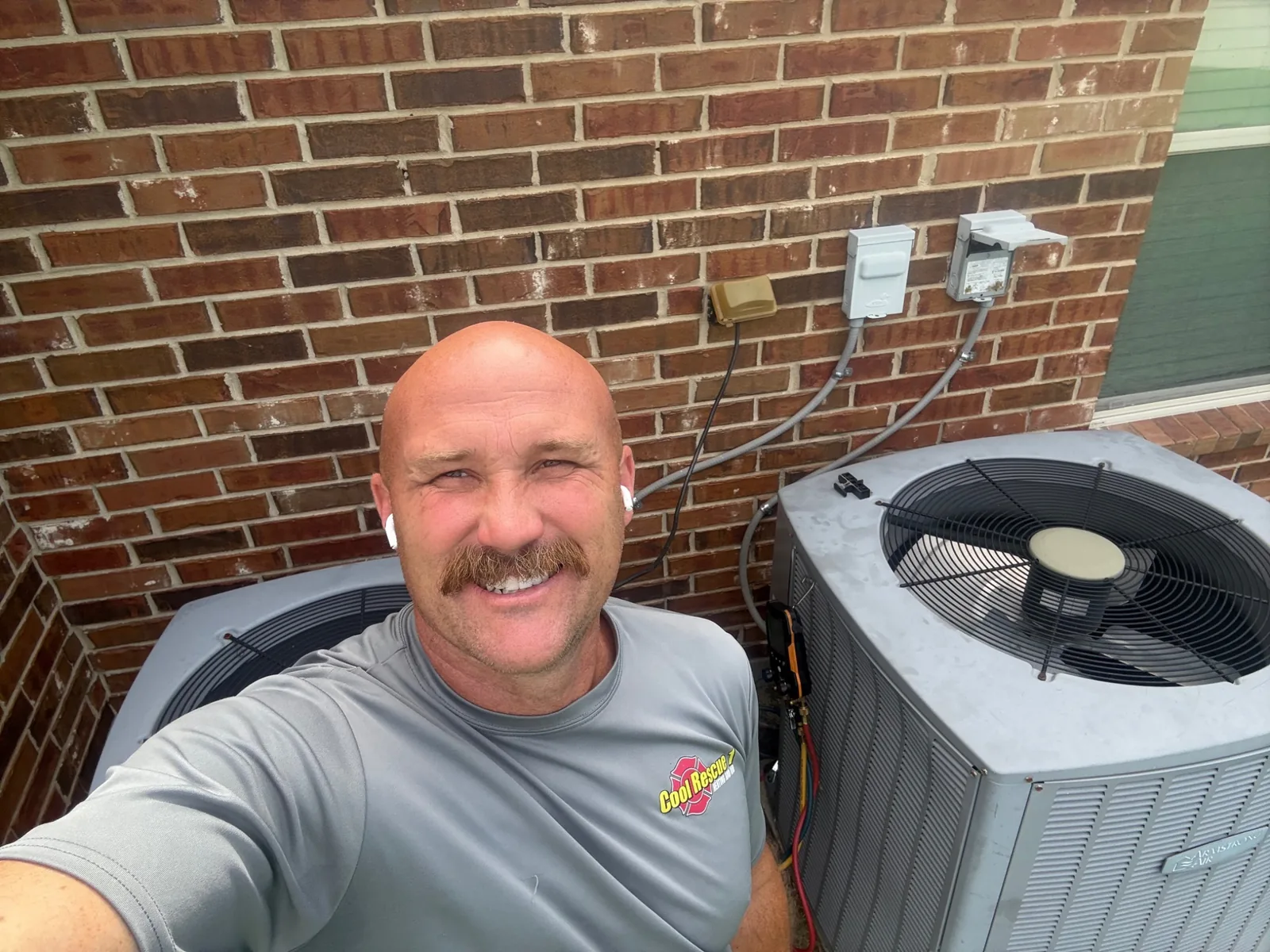 AC repair technician servicing a residential air conditioner in Caddo Mills, TX